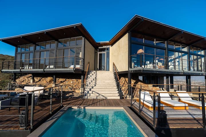 Casa Finch at dusk — the glass villa above its pool and the valley