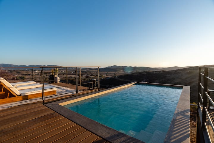 The infinity pool reaching toward the vineyards below