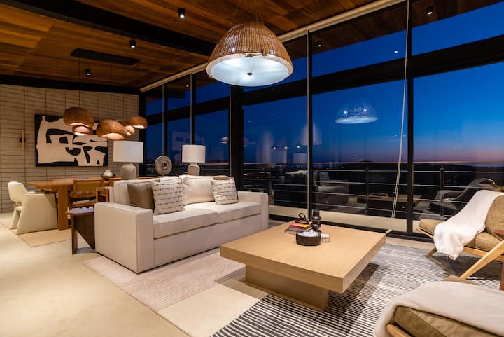 Warm light in the great room as night falls over the valley