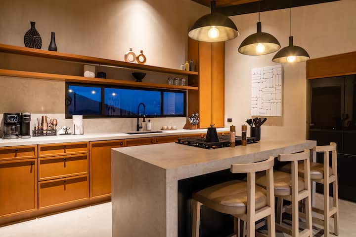 The kitchen — wood, stone and an island built for long lunches