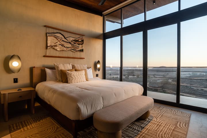 The primary bedroom with its wall of glass