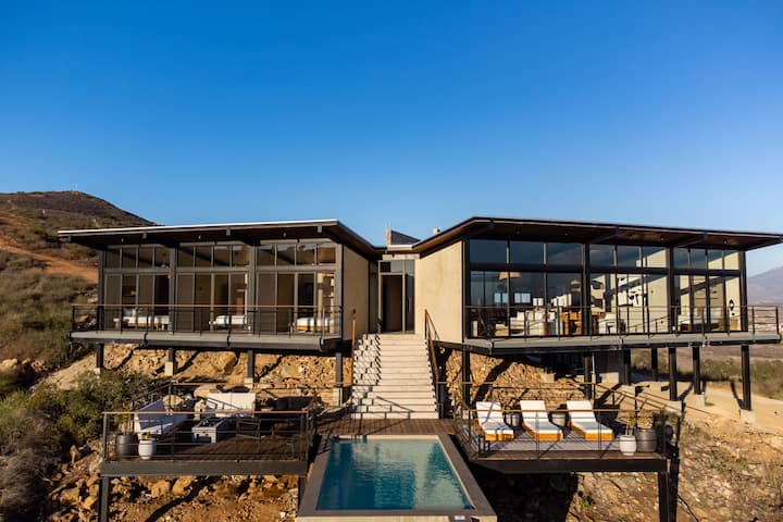 The lit villa and pool at the end of the day